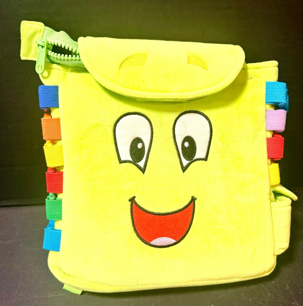 bright green plush Buckle Toys Buddy Activity Backpack featuring a smiling face